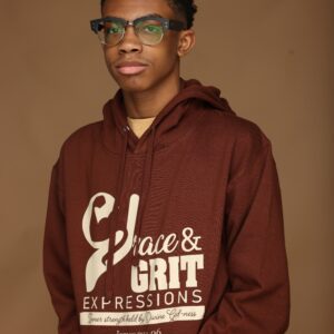 Young man wearing glasses and a maroon hoodie with text.