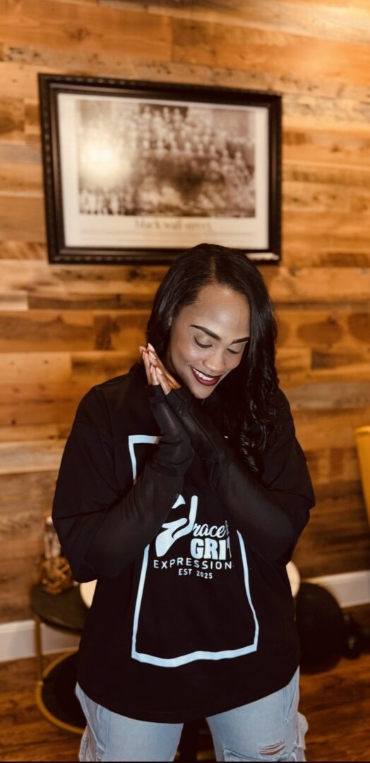 Woman smiling warmly in a cozy wooden interior.