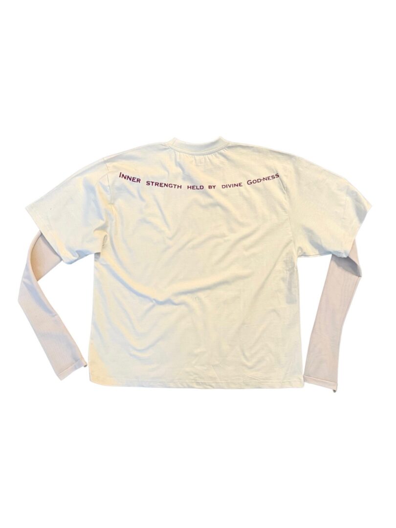 Beige long-sleeve shirt with black text along the upper back.