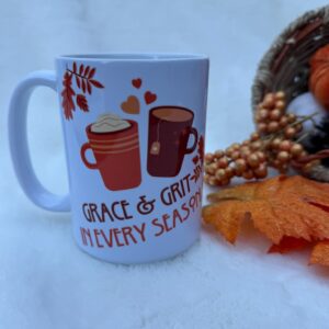 A festive mug with autumn-themed design and warm beverages.