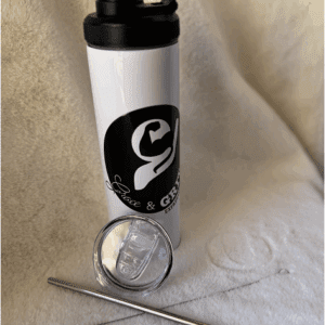 White shaker bottle with a black logo and accessories on a white surface.