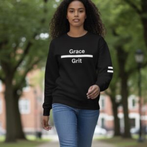 Young woman in a black sweatshirt walking outdoors.