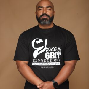 Man wearing a black "Grace & Grit Expressions" T-shirt.
