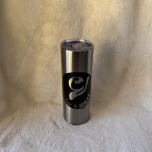 Stainless steel tumbler with a black and white logo on a soft beige background.