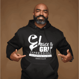 Man in black hoodie pointing to its graphic design.