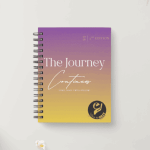 A spiral-bound journal with a purple-to-yellow gradient cover titled 'The Journey Continues'.