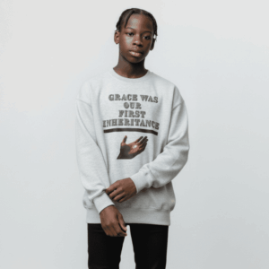 Person wearing a white sweatshirt with text and graphic design.