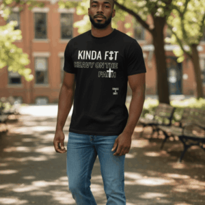 Man wearing a black graphic tee and jeans outdoors on a sunny day.