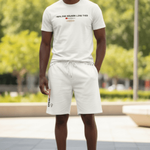 Man wearing a white t-shirt and shorts outdoors.